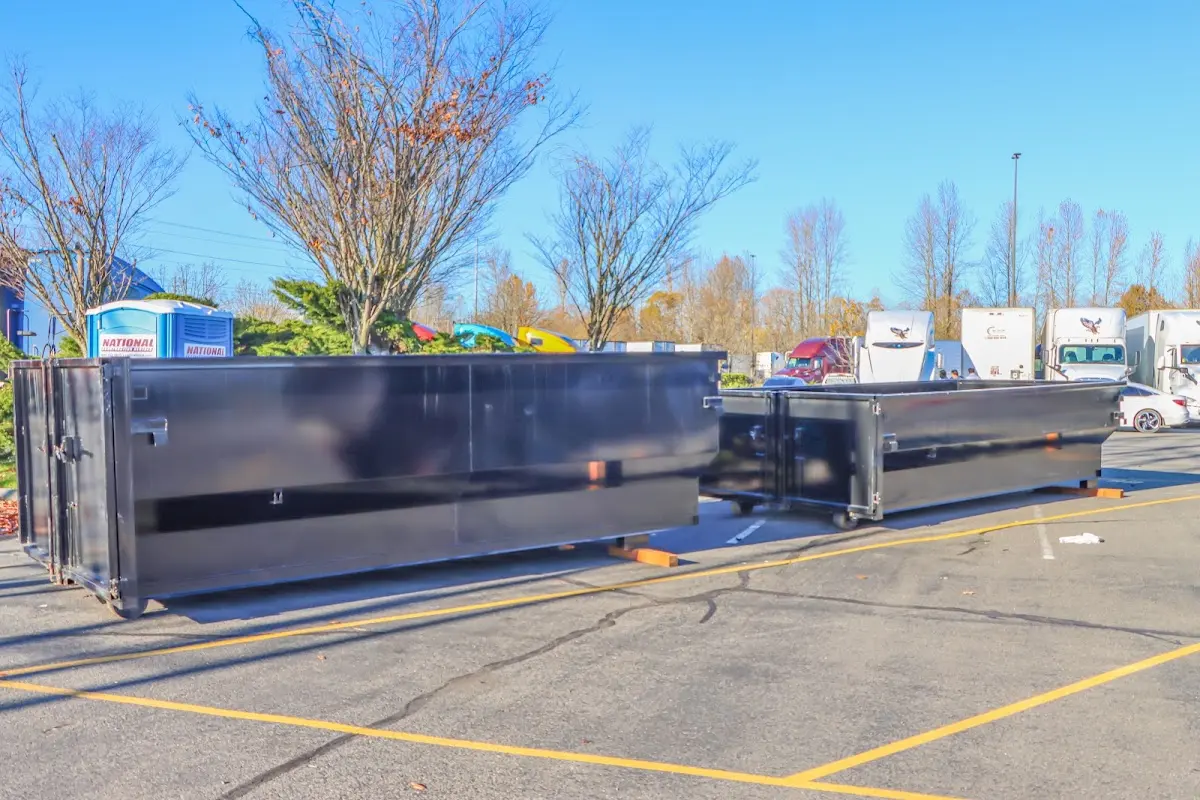 Professional dumpster rental service with roll-off container on residential driveway in Slidell